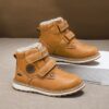 Child wearing stylish and warm Newness Adventure Ready Kids Snow Boots playing in the snow