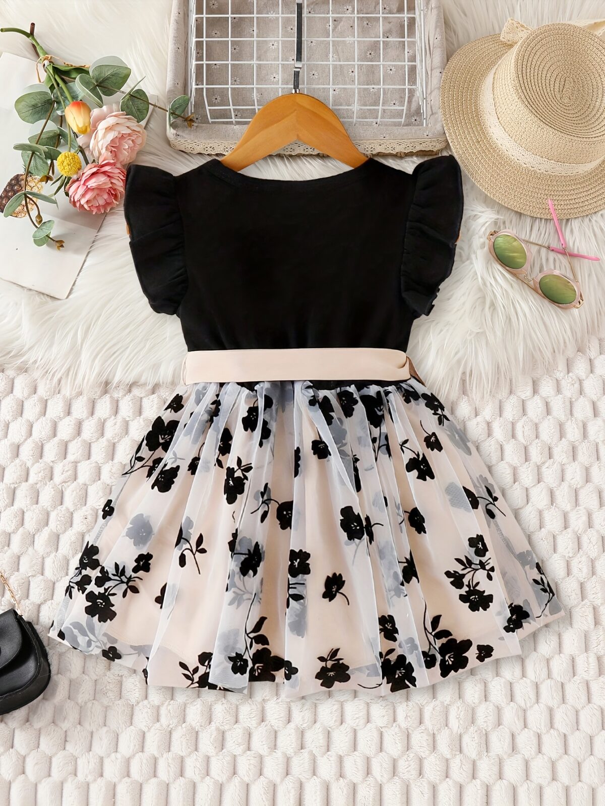 Adorable little girl twirling in a vibrant Summer Bloom floral print dress from Newness perfect for summer