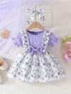 Adorable baby girl wearing a lightweight Summer Meadow floral print dress perfect for casual summer outings