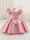 Adorable girl twirling in a lavender colored party dress perfect for birthdays and special occasions The dress features exquisite detailing and a flattering silhouette