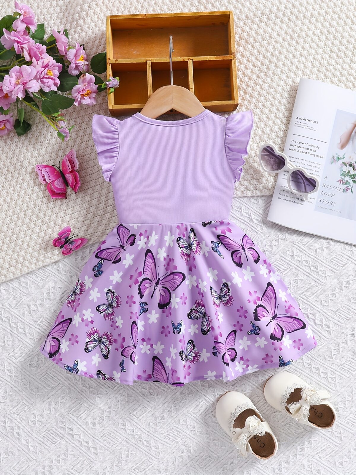 Adorable baby girl in a lavender butterfly dress perfect for summer Newness