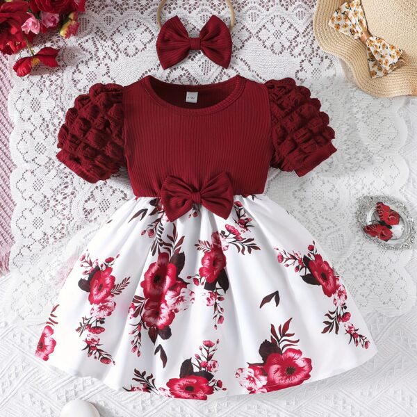 Adorable baby girl wearing a beautiful summer garden floral print dress