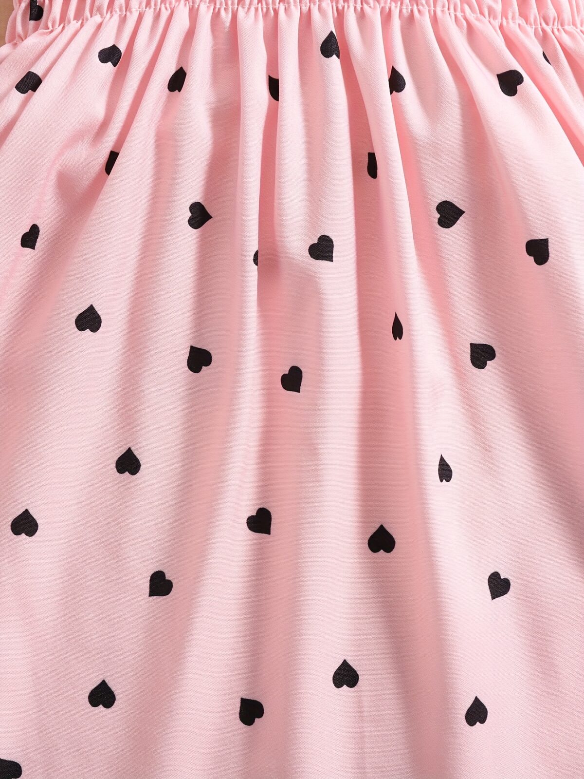 Girl wearing adorable Summer Bloom heart print dress and matching hat set