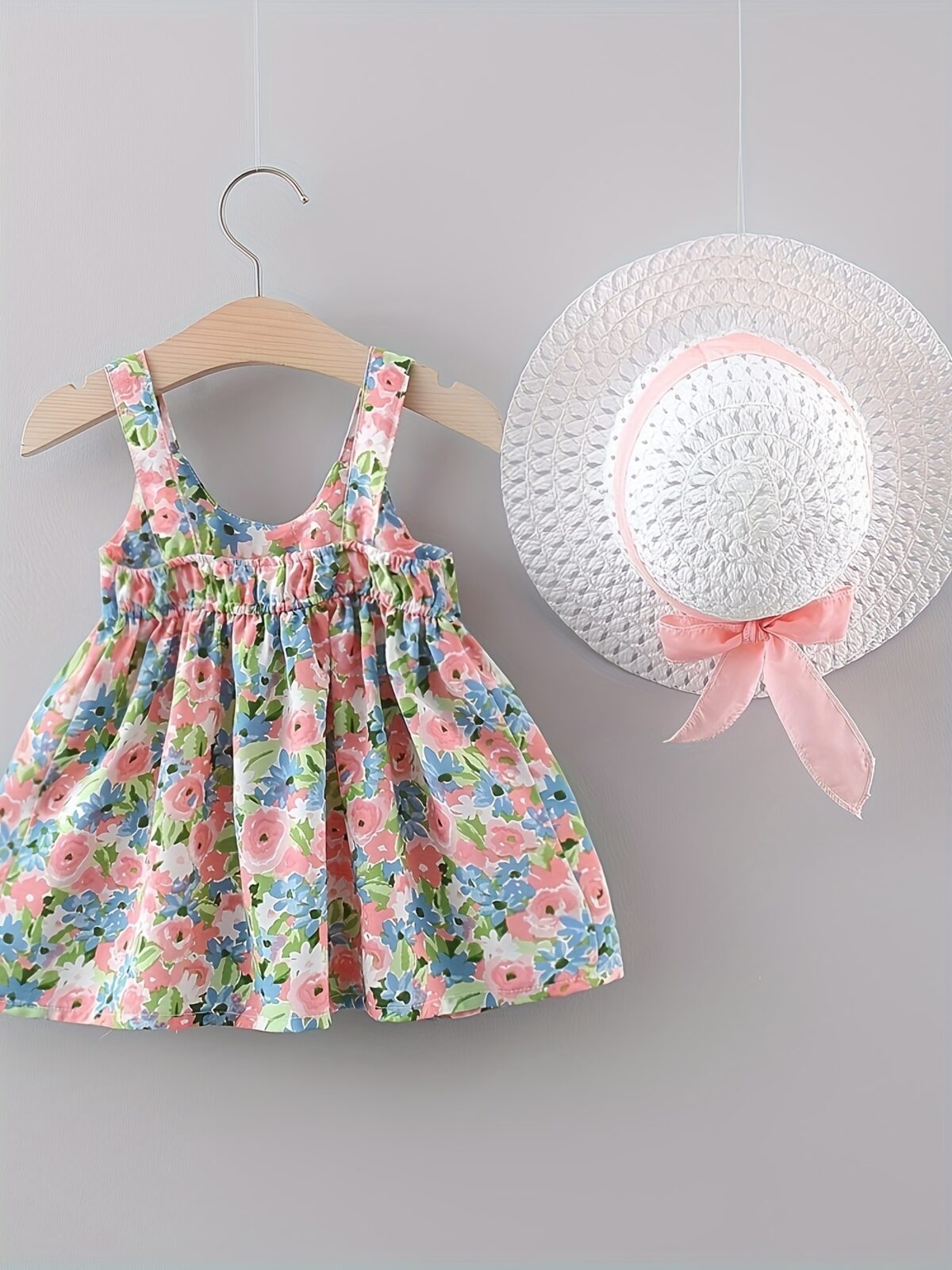 Baby girl wearing adorable Newness floral print dress and hat set perfect for summer