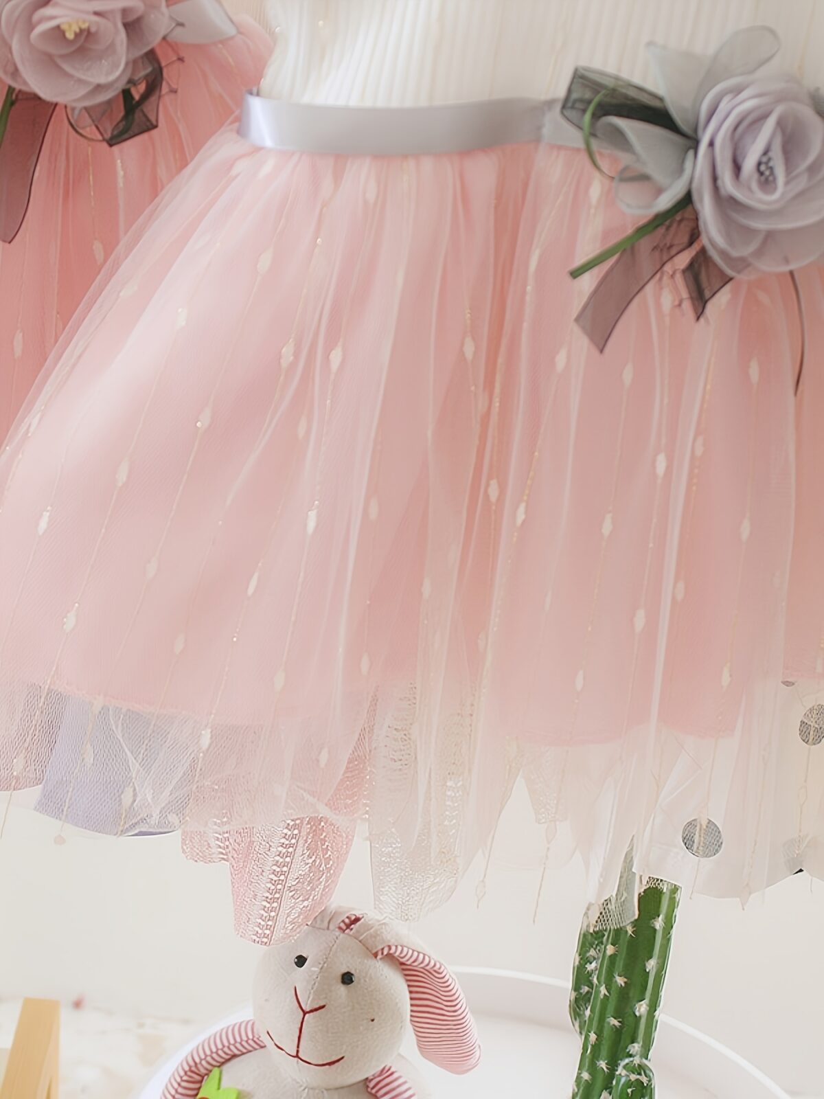 Adorable little girl twirling in a pink Summer Bloom Rose Princess Dress from Newness showcasing its comfortable and stylish design