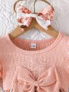 Adorable little girl twirling in a beautiful rosebud garden floral print dress perfect for weddings or a casual day out