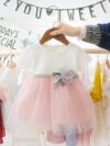 Adorable little girl twirling in a pink Summer Bloom Rose Princess Dress from Newness showcasing its comfortable and stylish design