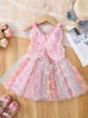 Adorable baby girl wearing a Flutterby Mesh Butterfly Dress a perfect summer outfit from Newness