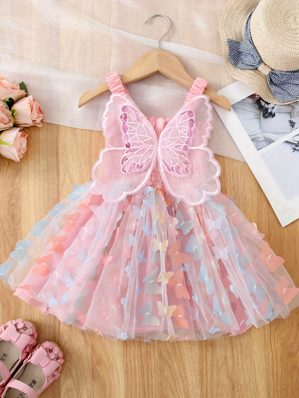 Adorable baby girl wearing a Flutterby Mesh Butterfly Dress a perfect summer outfit from Newness