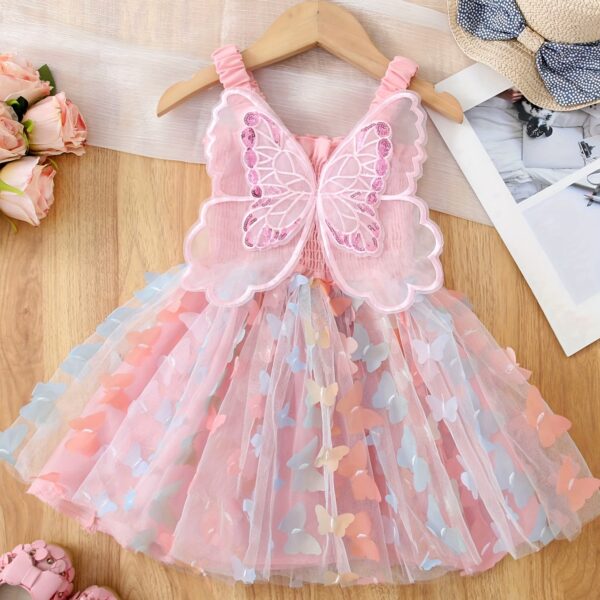 Adorable baby girl wearing a Flutterby Mesh Butterfly Dress a perfect summer outfit from Newness