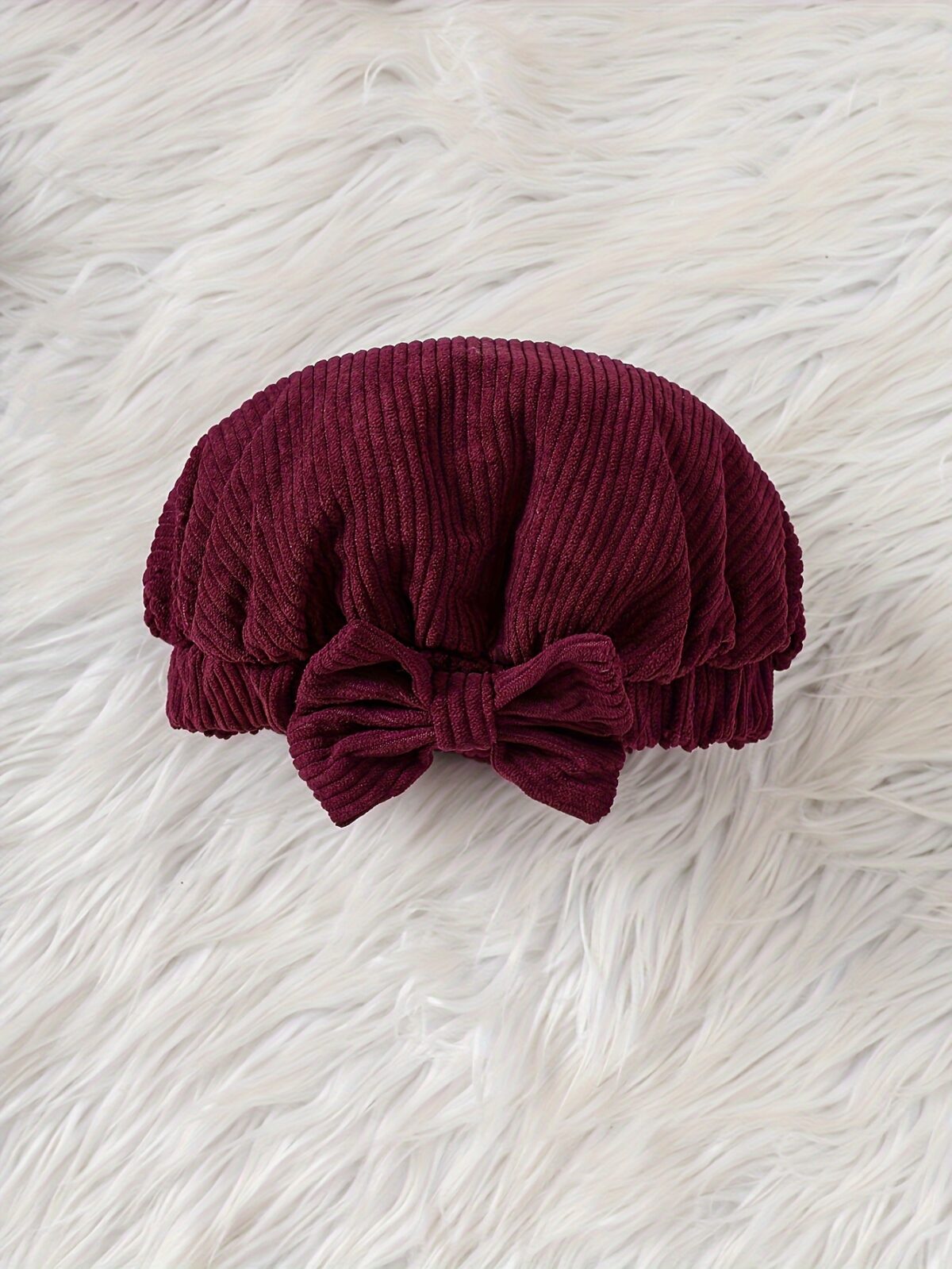 Adorable baby girl wearing a charming corduroy dress perfect for playtime or special occasions