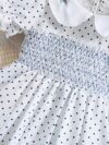Adorable little girl twirling in a charming summer polka dot dress perfect for birthdays and special occasions