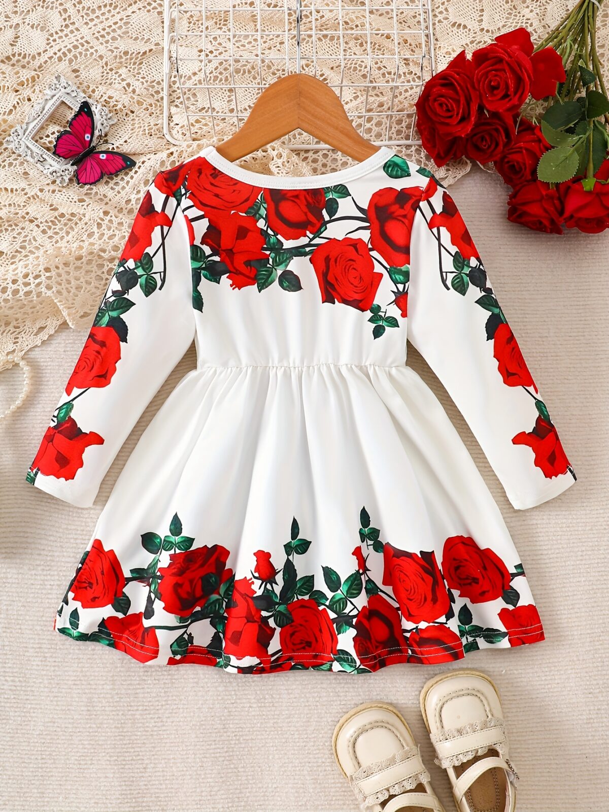 Adorable baby girl wearing a rose garden print dress perfect for fall and winter
