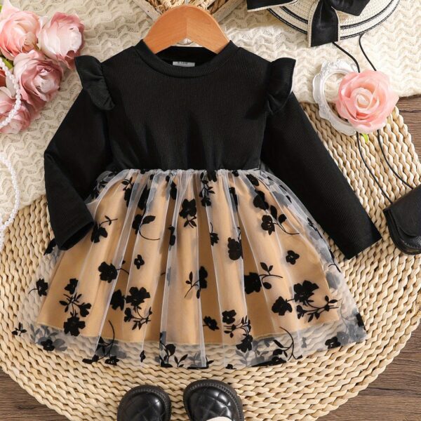 Baby girl wearing an adorable floral print dress perfect for spring or autumn
