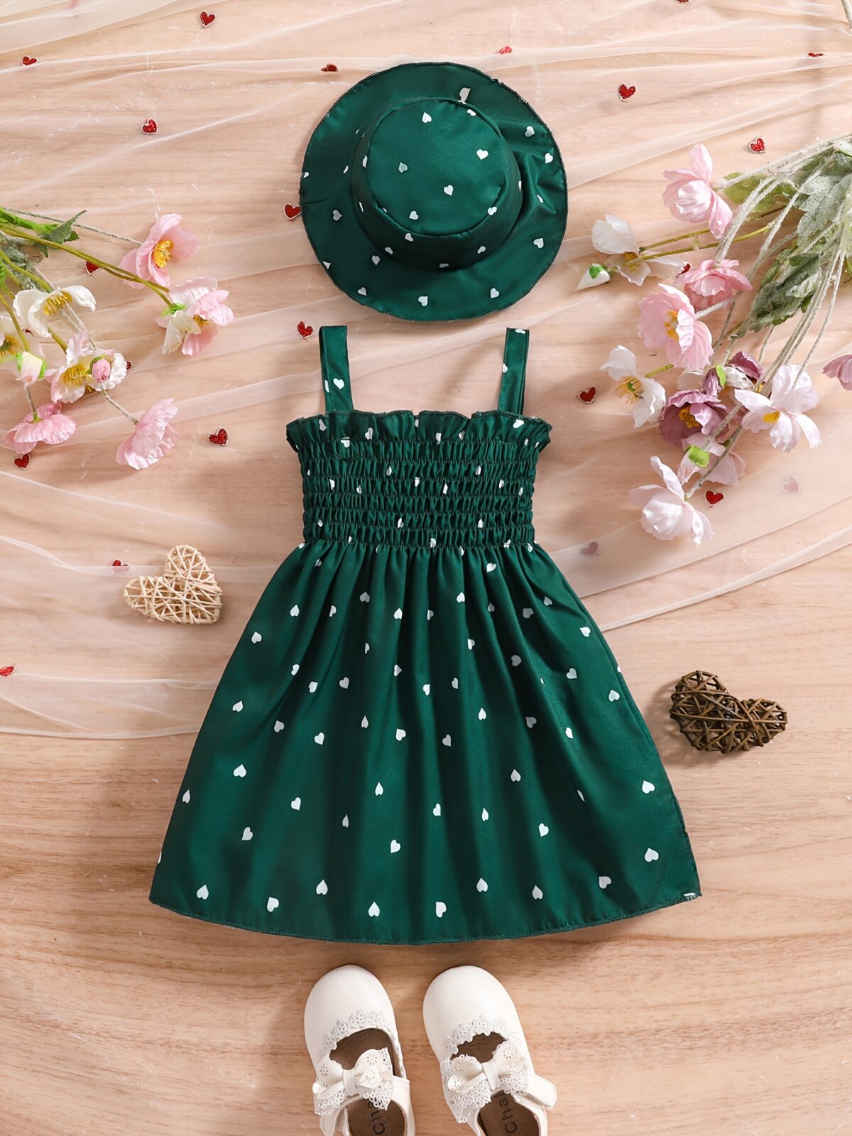 Girl wearing adorable Summer Bloom heart print dress and matching hat set