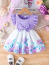 A little girl wearing a charming summer floral print dress
