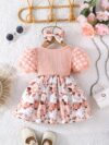 Adorable baby girl wearing a charming Seraphina floral print dress perfect for summer
