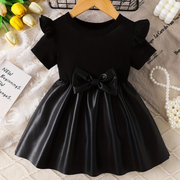 Adorable baby girl wearing a charming Little Darling Baby Bow Dress perfect for parties or playdates The dress features a beautiful bow detail