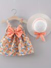 Baby girl wearing adorable Newness floral print dress and hat set perfect for summer