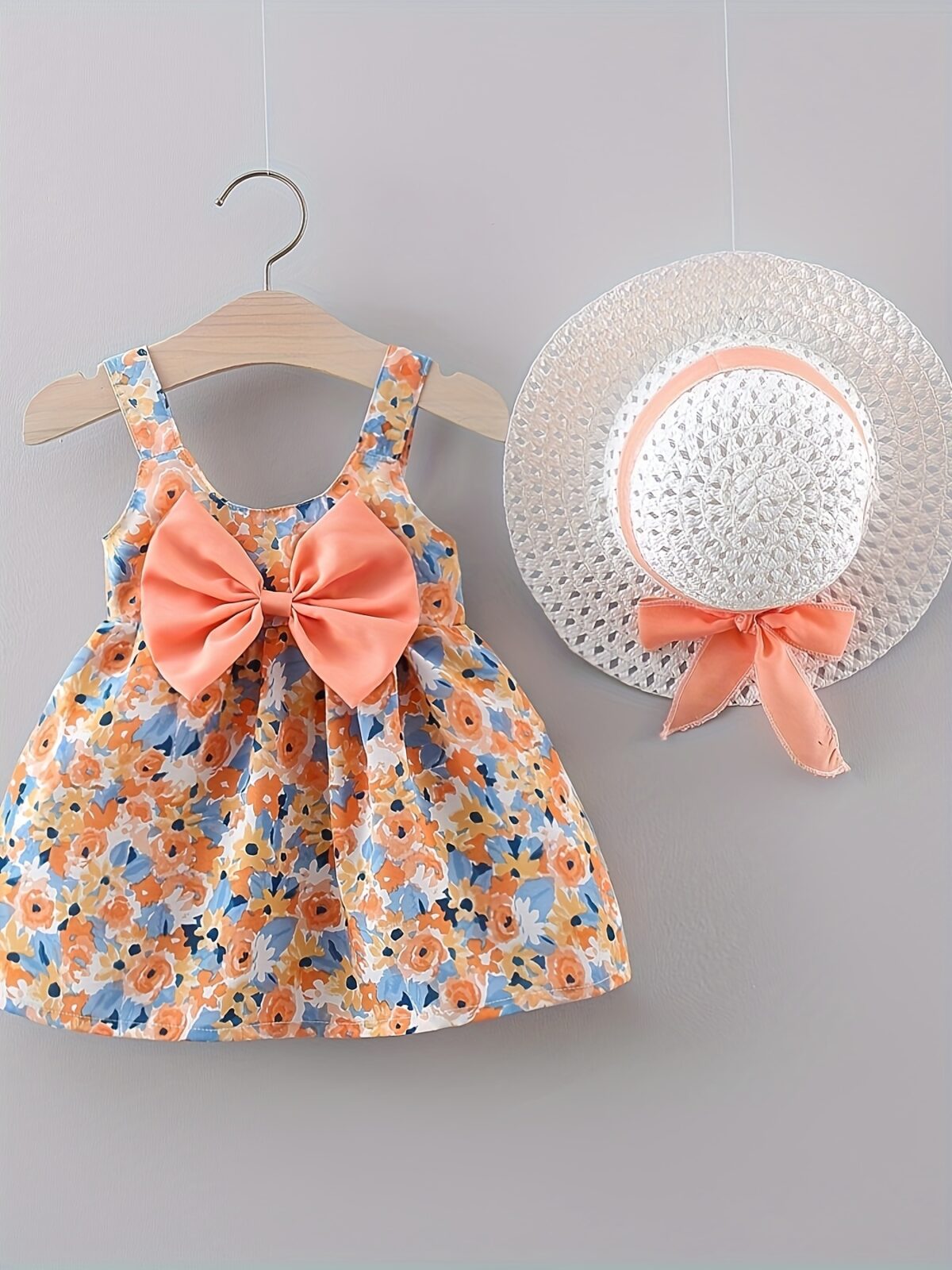 Baby girl wearing adorable Newness floral print dress and hat set perfect for summer