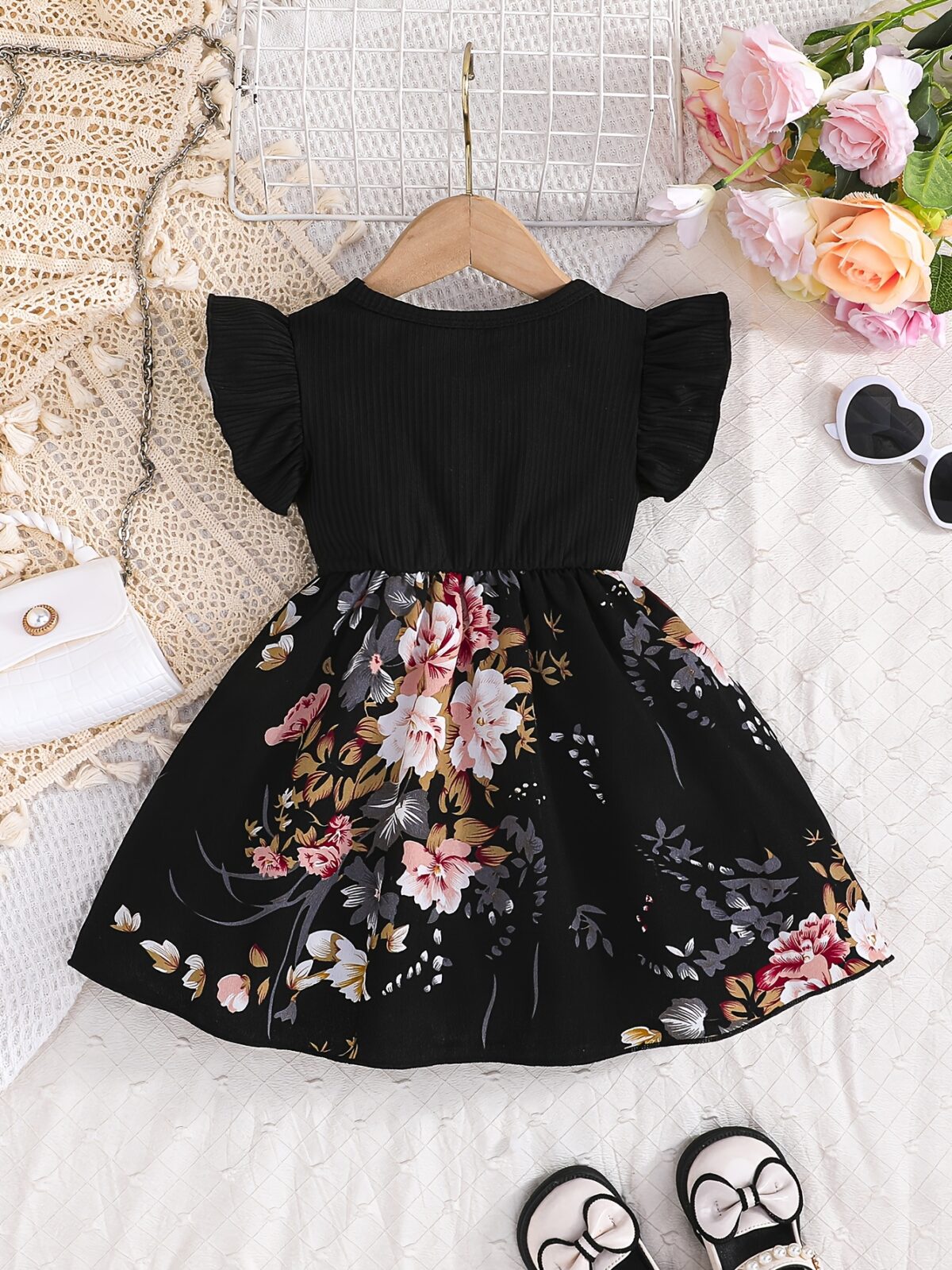 Adorable girl wearing a vibrant Summer Bloom floral print dress perfect for summer The dress features a playful colorful floral pattern