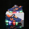 Boy wearing stylish Marvel Spider Man LED light up sneakers running and playing The sneakers light up showcasing vibrant colors