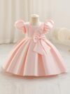 Adorable girl twirling in a lavender colored party dress perfect for birthdays and special occasions The dress features exquisite detailing and a flattering silhouette