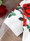 Adorable baby girl wearing a Rosalind floral print dress from Newness The dress features a charming floral pattern and is perfect for special occasions or everyday wear