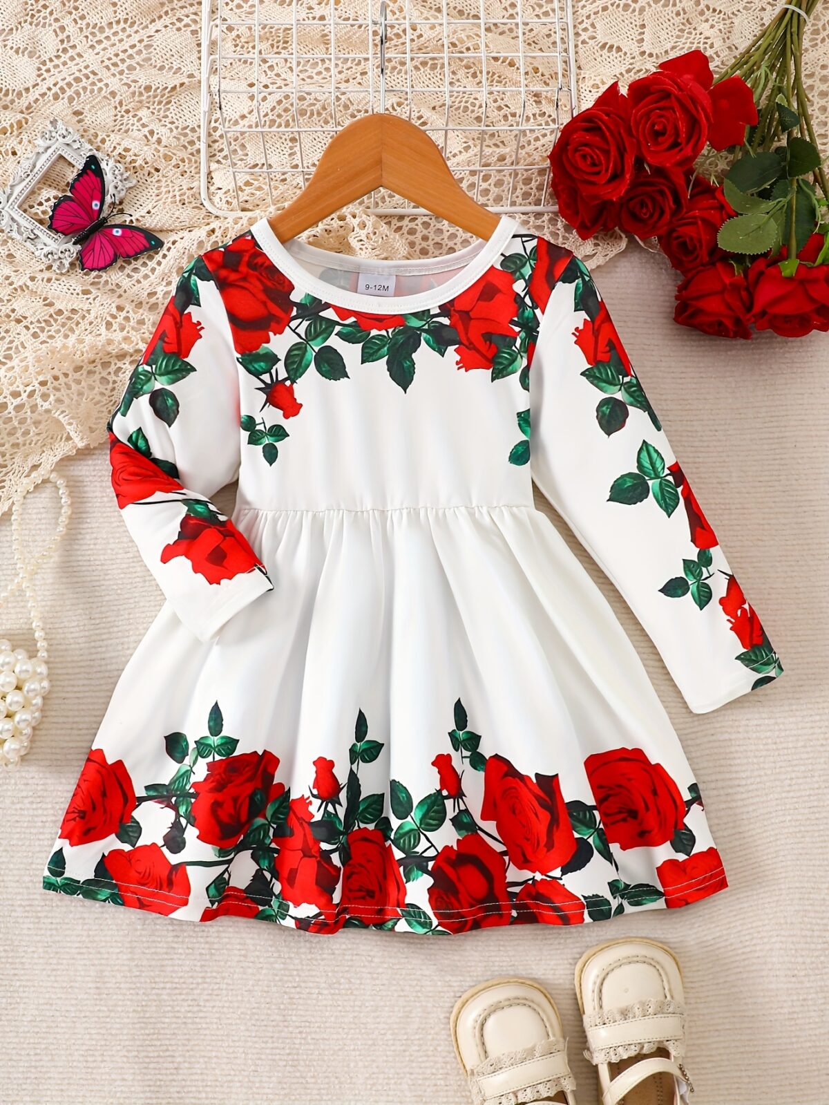 Adorable baby girl wearing a rose garden print dress perfect for fall and winter