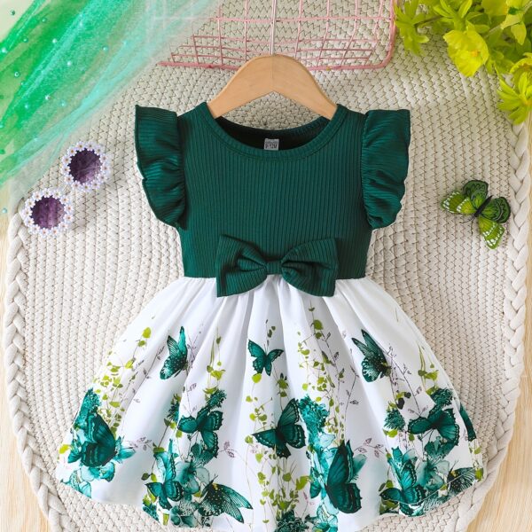 Adorable baby girl wearing a charming butterfly print dress from Newness perfect for spring and summer