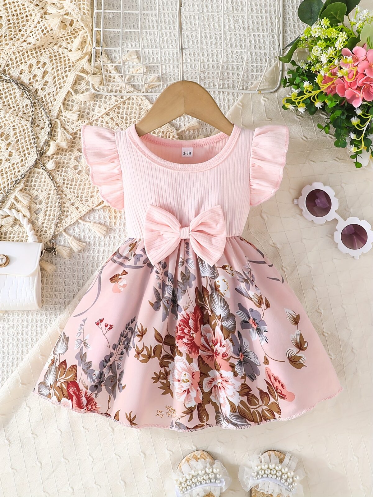 Adorable girl wearing a vibrant Summer Bloom floral print dress perfect for summer The dress features a playful colorful floral pattern