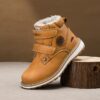 Child wearing stylish and warm Newness Adventure Ready Kids Snow Boots playing in the snow