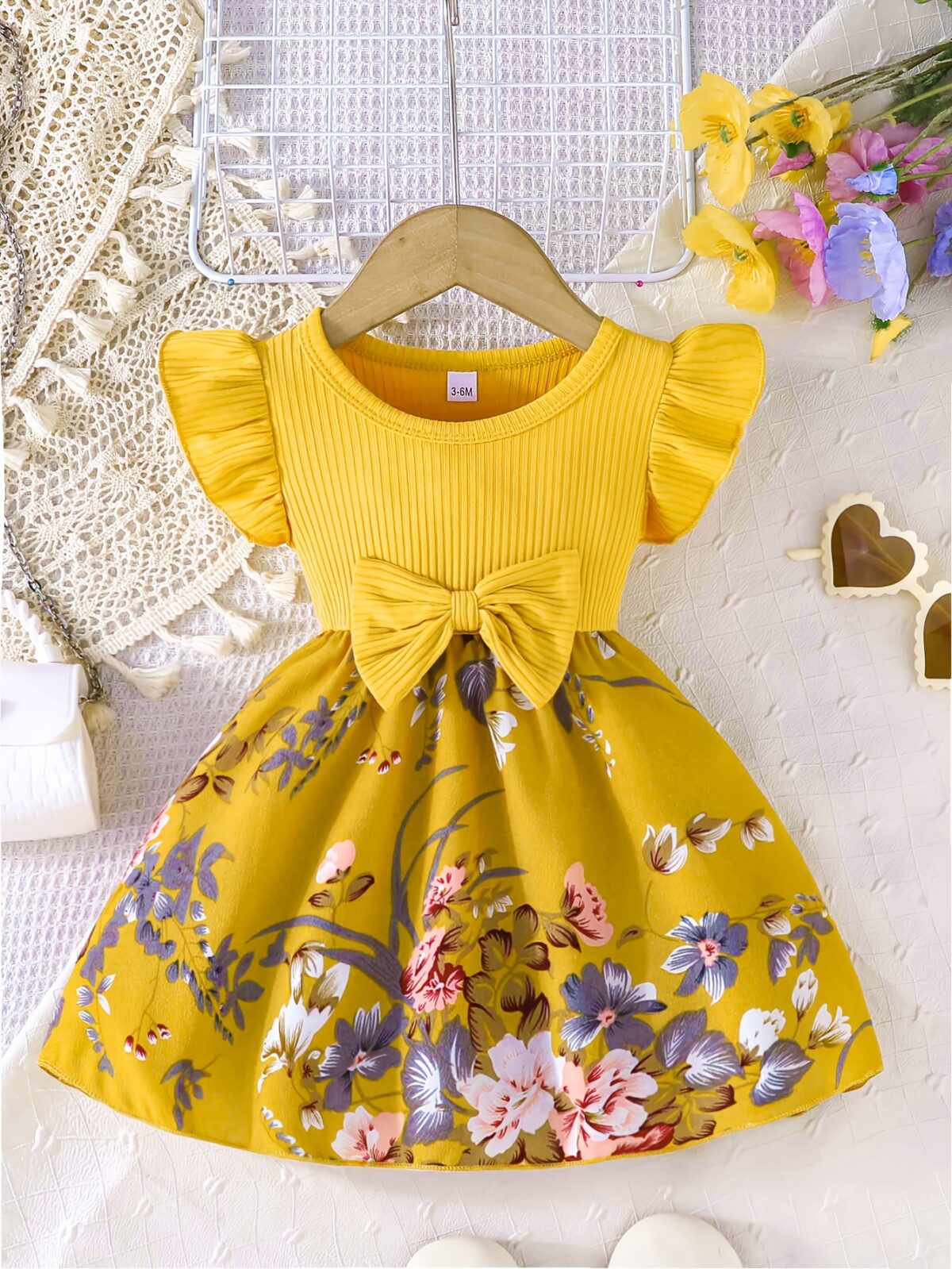 Adorable girl wearing a vibrant Summer Bloom floral print dress perfect for summer The dress features a playful colorful floral pattern