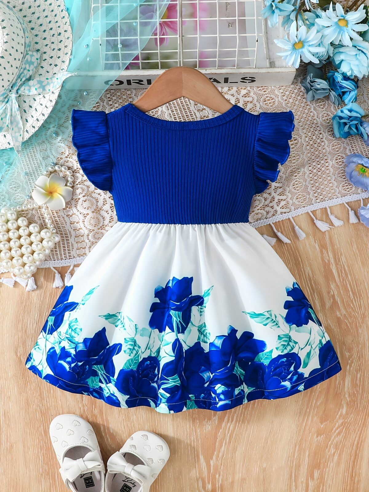 A little girl wearing a charming summer floral print dress