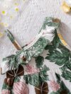 Baby girl wearing adorable Island Bloom floral print dress smiling