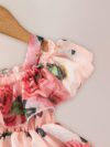 Adorable little girl twirling in a beautiful rose garden floral print dress Perfect summer outfit for kids