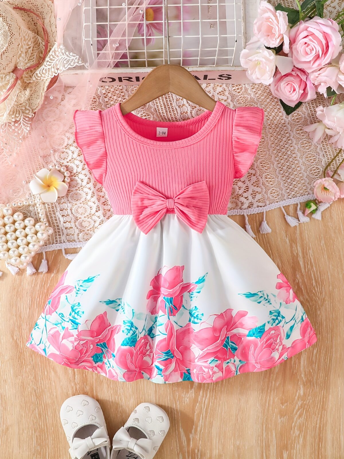 A little girl wearing a charming summer floral print dress