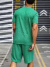 Model wearing the Newness Dubai Nights Mens Casual Sports Set a comfortable and stylish navy blue polyester athletic set perfect for lounging or working out