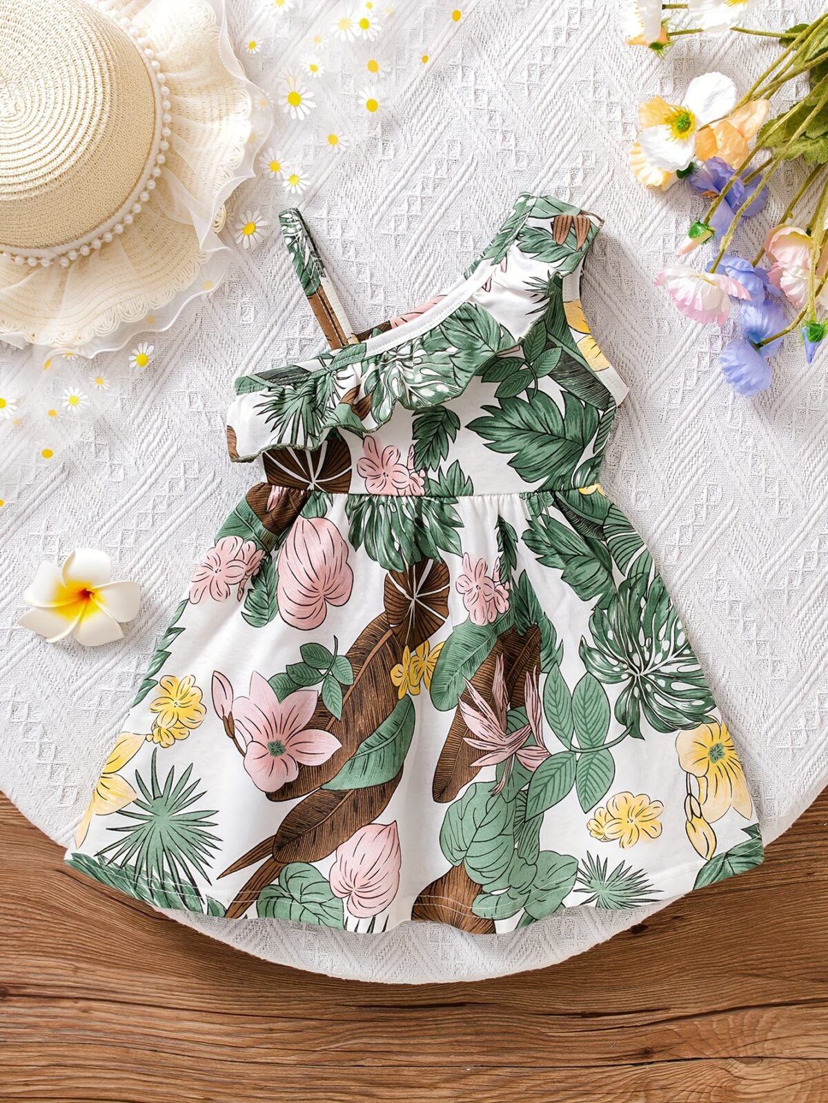 Baby girl wearing adorable Island Bloom floral print dress smiling