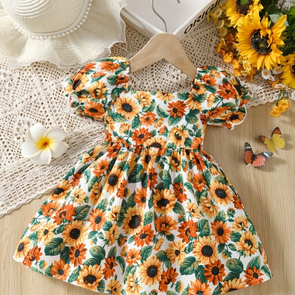 Baby girl wearing an adorable sunflower floral print dress perfect for summer