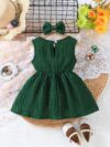 Toddler girl wearing a charming emerald green summer dress ideal for playing outdoors