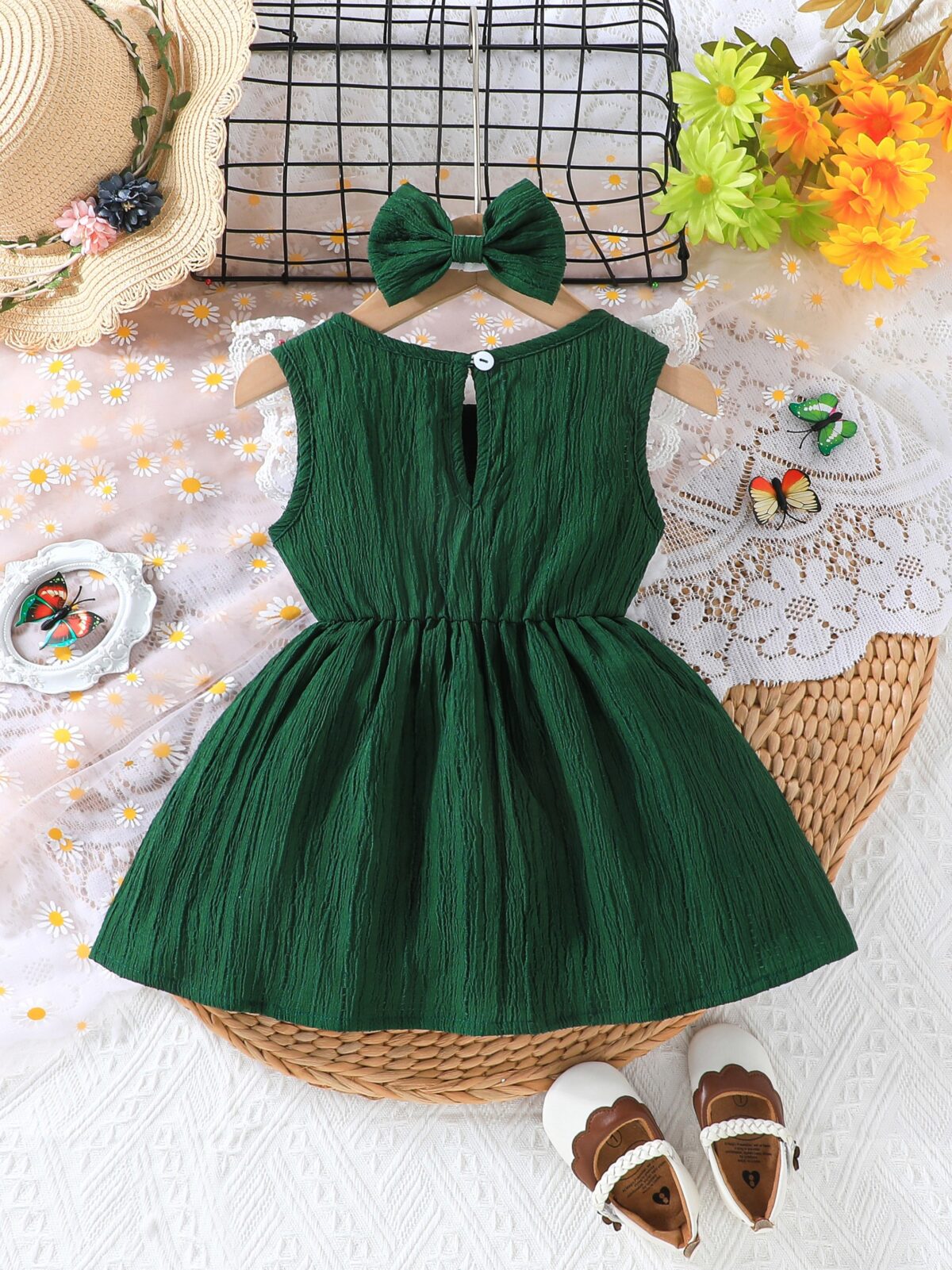 Toddler girl wearing a charming emerald green summer dress ideal for playing outdoors