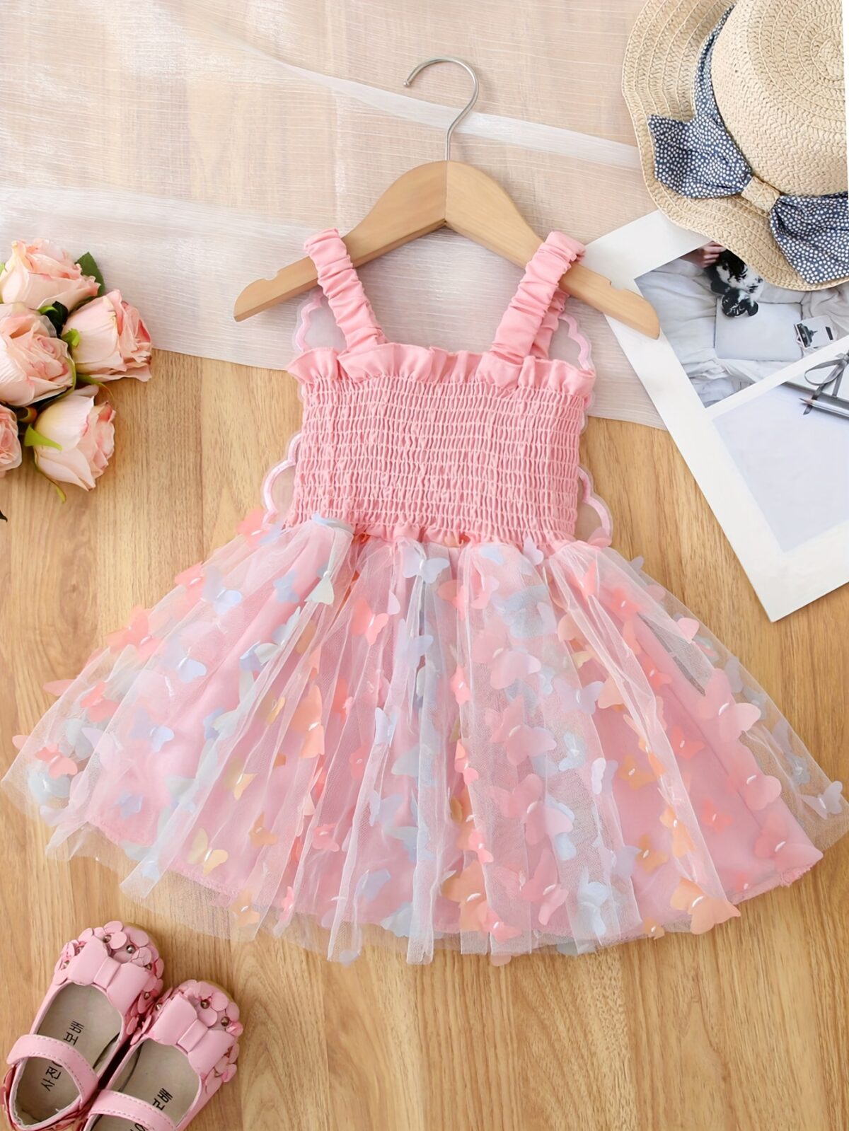 Adorable baby girl wearing a Flutterby Mesh Butterfly Dress a perfect summer outfit from Newness