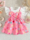 Adorable baby girl wearing a summer heart print dress perfect for school and special occasions