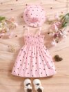 Girl wearing adorable Summer Bloom heart print dress and matching hat set
