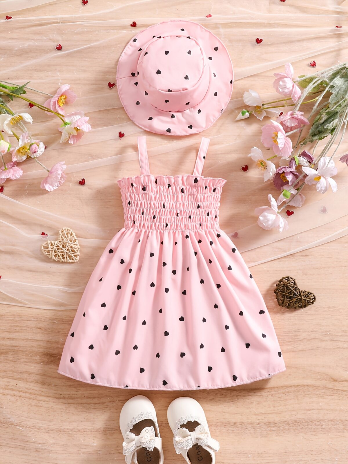Girl wearing adorable Summer Bloom heart print dress and matching hat set