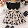 Adorable little girl twirling in a beautiful summer floral mesh dress from Newness The dress is lightweight and perfect for warm weather