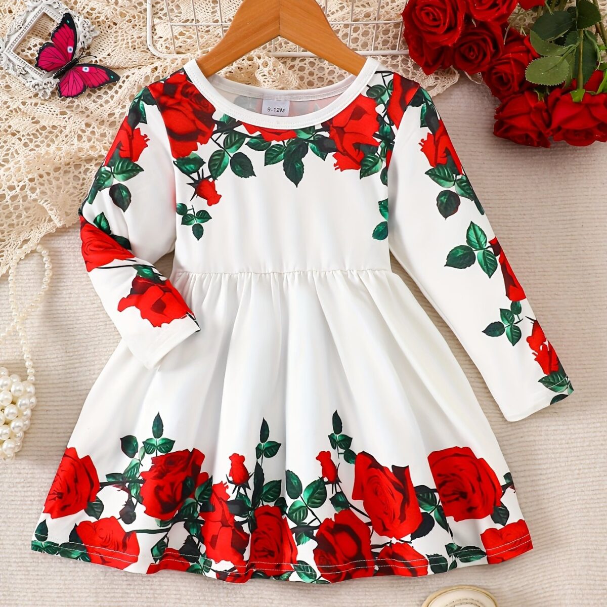 Adorable baby girl wearing a rose garden print dress perfect for fall and winter