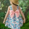 Girl wearing a charming summer floral print dress ideal for beach parties