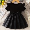 Adorable baby girl wearing a charming Little Darling Baby Bow Dress perfect for parties or playdates The dress features a beautiful bow detail